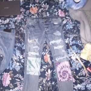 AMIRI Distressed Jeans with Vibrant Patches